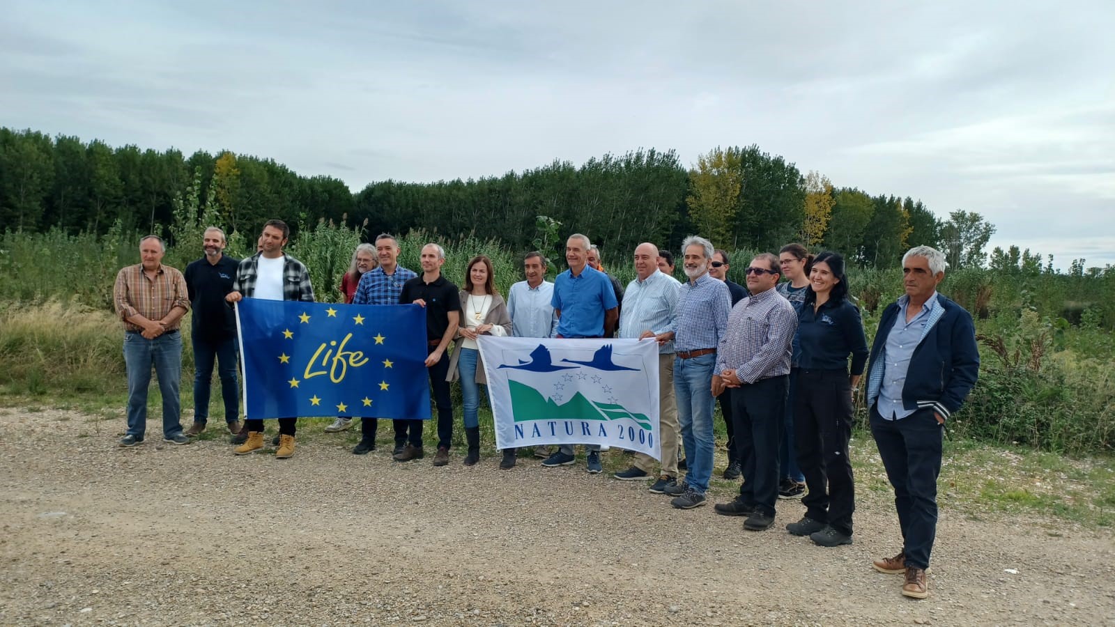 Grupo de representantes de Ayuntamientos y sindicatos navarros con la bandera LIFE en la visita a las áreas de inundabilidad de Aragón para conocer estas intervenciones.